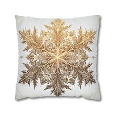 a gold and white pillow with an intricate design