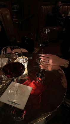 two glasses of wine are sitting on a table