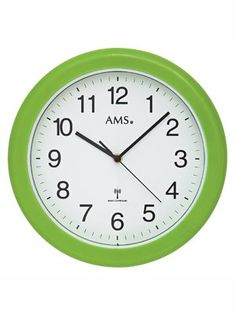 a green and white wall clock with the words ams on it's face