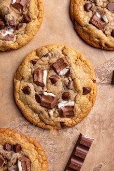 chocolate chip cookies with marshmallows are on a baking sheet and ready to be eaten