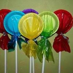 colorful lollipops with bows on them are lined up