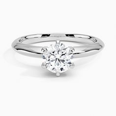 a round brilliant cut diamond engagement ring in 18k white gold, with tapered shans