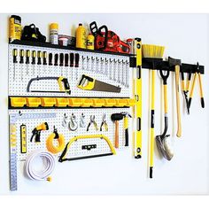 a wall mounted tool rack filled with tools