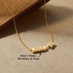 a gold plated necklace with the name baby's name, birth date and status engraved on it