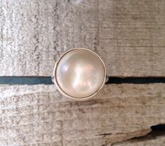 15mm White Cream Luminescent Mabe South Sea AAA Pearl set in Sterling Silver by GildedBug on Etsy White Mother Of Pearl Wedding Ring, Wedding Pearl Ring In Mother Of Pearl, Wedding Pearl Ring With Mother Of Pearl, White Mother Of Pearl Round Pearl Ring, White Moonstone Pearl Ring Gift, Elegant Iridescent Opal Ring With Cabochon, Elegant Iridescent Cabochon Opal Ring, Elegant Iridescent Cabochon Ring, White High Luster Pearl Ring