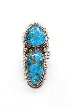 two turquoise stone rings sitting on top of each other