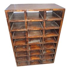 an old wooden bookcase with many compartments on it's sides and bottom shelf