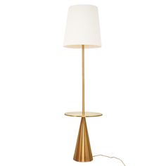 a table lamp with a white shade on the base and a cord plugged into it