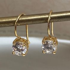 Great Pair of Vintage Sterling Silver Gold Vermeil Cubic Zirconia (CZ) Drop Pierced Earrings. These Have a Nice Gold Wash and Sparkly CZ. Perfect For the Holidays! The Drop is 3/4 Inch. Stone is Round and 4 Prong Set. Setting Measures 7mm. Marked 925 Thailand HAN Excellent Very Gently Worn Condition! Gold Round Bridal Earrings With Ear Wire, Classic Gold Earrings With Sparkling Stones, Classic Gold Diamond Earrings For Party, Elegant Gold Crystal Earrings With Prong Setting, Classic Cubic Zirconia Earrings, Gold Crystal Earrings With Prong Setting For Formal Occasions, Gold Crystal Earrings With Prong Setting For Formal Events, Elegant Gold Round Crystal Earrings, Dazzling Round Gold Crystal Earrings