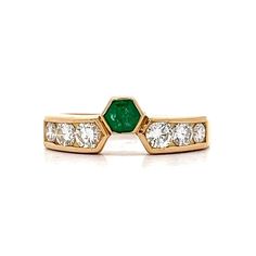 Emerald & Diamond Stacking Ring in 18k Yellow Gold This fun ring features a single emerald in 18k yellow gold with diamond accents.  The emerald has a weight of .17 carats and has a unique hexagon shape.  The emerald is accented by six (6) round brilliant cut diamonds of graduated sizes.  The exquisite diamonds have a color grade of F/G which gives the ring a very luxe look. The 18k yellow gold combined with the emerald and diamonds makes this a very compelling stacking band. PRIMARY STONE Stone: Emerald Shape: Other Weight: .17 ct Measurements: 3.50 mm x 3.50 mm = .17 ct (1) ACCENT STONE Accent Stone: Natural Diamond Color and Clarity: F/G, VS2-SI1 Weight: .32 ct Measurements: 2.8 mm = .08 ct (4) Secondary Accent Stone: Natural Diamond Secondary Measurements: 2.3 mm = .045 ct (2) Secondar Luxury Yellow Gold Open Ring Emerald, Luxury Emerald Ring With Tension Setting, Yellow Gold Emerald Ring With Tension Setting, Green Diamond Ring With Single Cut Emerald Shape, Yellow Gold Emerald-cut Ring With Single Cut Diamonds, Green Emerald Cut Diamond Ring With Single Cut Diamonds, Luxury Asscher Cut Yellow Gold Emerald Ring, Formal Emerald Diamond Ring With Tension Setting, Octagon Emerald Ring In Yellow Gold With Brilliant Cut