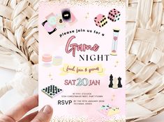 a person holding up a pink and gold game night party card