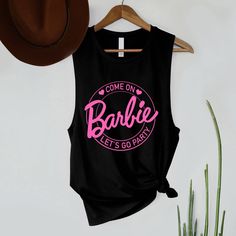 Come On Barbie Let's Go Party lettering with circle and hearts art printed 100% airlume combed and ringspun cotton, 32 singles -Heather color, Mauve - 70% Cotton 30% Polyester -Retail fit. -Women's Muscle tank top S : Chest 15 1/4" / Length 24 1/2" M : Chest 16" / Length 25" L : Chest 17" / Length 25 1/2" -Low-cut armhole -Curved bottom hem -Side seams. Party Tank Top, Barbie Top, Heart Art Print, Womens Muscle Tank, Muscle Tank Top, Women's Muscle, Muscle Tank Tops, Minnie Ears, Muscle Tank