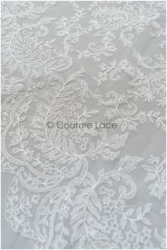 white lace with flowers and leaves on grey fabric, suitable for wedding dress or bridal gown