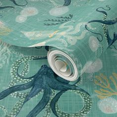 an octopus print wallpaper with blue and green colors on the bottom half of it