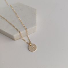 "Dainty gold heart necklace. Created and finished by hand in either 14k gold fill or sterling silver. Charm measures 3/8\". To Purchase simply select the material and chain you would like from the drop down menu then click \"Add to cart\"." 14k Gold Filled Initials Necklace For Everyday, Simple Tiny Initial Pendant Necklace, Minimalist Round Heart Necklace For Everyday, Minimalist Heart Necklace For Everyday, Simple Hand Stamped Necklace As Gift, Minimalist Everyday Heart Necklace, Minimalist Jewelry With Heart Charm On Round Pendant, Minimalist Jewelry With Heart Charm Round Pendant, Dainty Hand Stamped Necklaces For Anniversary