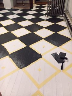 a black and white checkered floor with an umbrella laying on the ground next to it