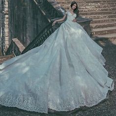 a woman in a wedding dress standing on some stairs