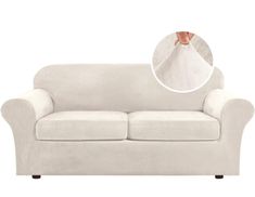 a white couch with the cover pulled down to show it's arm and foot