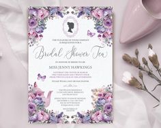 a purple and white floral bridal shower party with pink flowers, teapots and butterflies