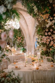 the table is set with flowers and candles