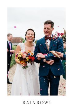 a man and woman are walking through confetti