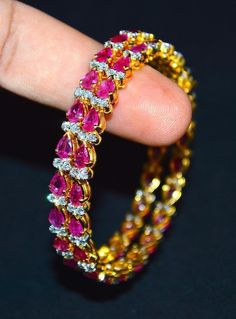 "1 solid 18k gold 10.35cts diamond and ruby bangle f-g color and vs clarity untreated natural diamonds and untreated natural pinkish red rubies. extremely high end - top quality bangle (i have 2 bangles, but this listing is of one bangle. please contact me if you are interested in both bangles) here is the description of one bangle: this is a custom made top quality ruby and diamond bangle. the bangle is loaded with 1.71cts of round brilliant cut diamonds and 22 pear cut natural red rubies total Diamond Yellow Gold Bangle With 17 Jewels, Yellow Gold Diamond Bangle With 17 Jewels, Yellow Gold Diamond Bangle With Jewels, Diamond Bangle With Brilliant Cut, Dazzling Diamond Bangle With Single Cut Diamonds, Diamond Bangle With Single Cut Diamonds, Fine Jewelry Yellow Gold Bangle For Party, Exquisite Diamond Bangle With Single Cut Diamonds, Diamond Bangle In Yellow Gold For Party