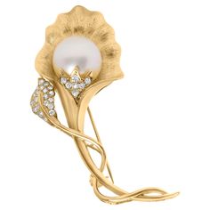 Experience the epitome of elegance with this stunning 18K yellow gold brooch, where the artistry of hammered gold is brought to life in an enchanting flower and leaf motif. At its heart lies a luminous 12MM cultured South Sea pearl, its white sheen reflecting a subtle radiance that is gracefully emphasized by an array of natural diamonds nestling its base and trailing delicately along a leaf. These diamonds, remarkable for their G-H color and VS1-VS2 clarity, sparkle with an understated yet undeniable brilliance. Fastened securely with a pin clasp on the reverse, this brooch promises not only to adorn but to awe, making it a luxurious addition to any attire or a cherished gift for someone special. Product Features: Diamond Type: Natural White Diamonds Diamond Count: 27 Round-Cut Diamonds D Vs2 Diamond, Gold Brooch, Sea Pearl, Hammered Gold, Gold Brooches, Diamond Settings, South Sea Pearls, Sea Pearls, Pearl Flower