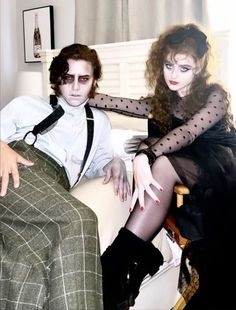 a man and woman sitting on a chair in front of a window with polka dot stockings