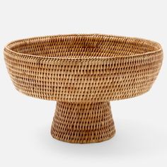 a wicker bowl is shown on a white background, with the bottom half turned down