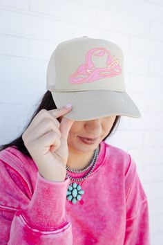 A funky Tan trucker hat featuring a pink cowboy hat graphic. Trendy Wide Brim Trucker Hat, Pink Western Cap Hat, Western Style Pink Cap, Pink Western Style Cap, Trendy Baseball Cap With Curved Brim For Rodeo, Spring Rodeo Trucker Hat, One Size Fits Most, Adjustable Wide Brim Trucker Hat In Trendy Style, Spring Rodeo Trucker Hat One Size Fits Most, Trendy Snapback Baseball Cap For Rodeo