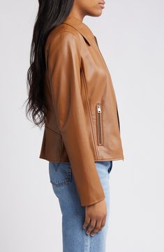 This sporty zip-front jacket is updated in a deep forest hue and crafted from sleek faux leather. 20" length Front zip closure Spread collar Long sleeves with zip cuffs Side zip pockets Water-resistant Lined 100% polyurethane Machine wash, tumble dry Imported