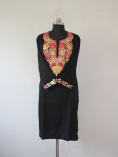 Embrace effortless elegance with a Kashmiri Aari embroidered cotton kurti.The cool, breathable comfort of cotton is elevated by the meticulous artistry of Aari work. This traditional embroidery technique utilizes a long needle to create stunning designs directly onto the fabric. Imagine delicate floral patterns, geometric motifs, or even enchanting paisleys adorning the kurti, each stitch imbued with the skill of Kashmiri artisans. The result is a garment that's both beautiful and versatile, perfect for adding a touch of cultural flair to your everyday wardrobe. Product Details - Condition: Brand New - Handmade - Style: Kurti Tunic - Fabric: Ruby Cotton - Embroidery: Kashmiri Aari Embroidery - Embroidery Color: blue - Kurti Length: 42" Inch - Kurti Chest: 42'' Inch - Care Instructions: Han Bohemian Chanderi Kurta With Embroidered Neckline, Bohemian Cotton Embroidered Dress For Festive Occasions, Fitted Bohemian Cotton Silk Kurta, Traditional Cotton Embroidered Tunic Dress, Spring Cotton Salwar Kameez With Resham Embroidery, Spring Resham Embroidered Cotton Salwar Kameez, Embroidered Chikankari Straight Kurta Dress, Festive Multicolor Embroidered Straight Kurta Dress, Folk Style Cotton Embroidered Dress With Resham Embroidery