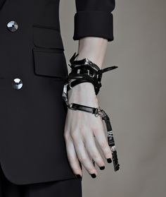 The Leather Bracelet doubles as a bold arm cuff or a versatile black necklace. This avant-garde piece of vegan jewelry is gender-neutral and perfect for those who love a maximalist style. Ideal for making a statement at any party.  𝐒𝐈𝐙𝐄: ➤ Fully Adjustable. ➤ Circumference 51″ (130 cm) measured flat; ➤ Wrap around neck, wrist, arm, ankle, etc.  𝐃𝐄𝐓𝐀𝐈𝐋𝐒: ➤ Materials: Faux Leather, Mixed Metal, Black Acai Beads, Suede Cord ➤ Ready to Ship ★ Gift Ready -Rannka's black leather cross necklace /choker/bracelet is very flexible and provides various ways to style it.  -Made with custom made black faux leather links and mixed metal, this item features a bold black nut bead cross.   𝐇𝐎𝐖 𝐓𝐎 𝐖𝐄𝐀𝐑 𝐈𝐓? Rogue necklace/bracelet can be wrapped several times around wrist and neck with Edgy Metal Jewelry With Black Band, Edgy Silver Jewelry With Black Band, Black Punk Bracelets, Punk Black Bracelets, Punk Black Bracelet, Black Punk Cuff Jewelry, Edgy Black Bracelet Strap Jewelry, Edgy Style Bracelet Jewelry, Adjustable Black Cuff Bracelet For Fashion