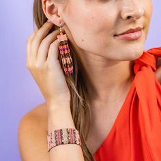 Embrace the vibrant spirit of Jaipur with the Billie Mixed Horizontal Stripes Fringe Earrings! Featuring Peach, Bronze, Coral, and Magenta hues, these earrings are a playful addition to your jewelry collection. The intricate design with tiny glass beads offers a delicate and feminine look that's perfect for any occasion. --DETAILS-- 3.3" L, .62" W Handmade by skilled artisans in India Hypoallergenic nickel + lead-free brass hardware These accessories are made by human hands. A slight variation i Fusion Style Colorful Beads Jewelry For Festival, Festive Adjustable Beaded Earrings With Colorful Beads, Bohemian Pink Jewelry With Dangling Beads, Pink Bohemian Beaded Earrings For Festive Occasions, Bohemian Pink Beaded Earrings For Festive Occasions, Pink Festival Jewelry With Latkans, Pink Latkan Festival Jewelry, Pink Bohemian Jewelry For Festive Occasions, Festive Bohemian Pink Beaded Earrings