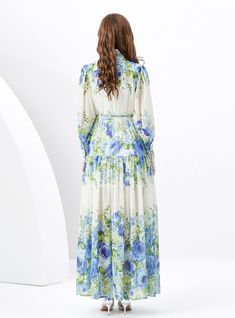 Oasis of Elegance: This stunning maxi dress is a true oasis for the eyes, flourishing with blue florals reminiscent of a serene, sunlit meadow. The lightweight fabric cascades gracefully from the demure, high-neck collar down to the soft, billowing hem, creating an impression of noble sophistication. With a tailored waist accented by a delicate belt, this dress offers a silhouette that's both flattering and enchanting. The full-length button placket adds a touch of classic charm, while the combination of sheer and opaque fabrics brings a modern twist to this timeless piece. Ideal for garden parties or elegant daytime events, this dress promises a look of refined beauty and an air of poetic poise. Fabric name: chiffonPattern: printingSkirt length: long skirtSleeve length: long sleevesColor: Simple Belt, Blue Florals, Garden Parties, Printed Dress, Neck Collar, Retro Dress, Printed Skirts, Button Placket, Skirt Length