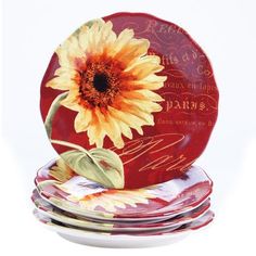 a stack of plates with a sunflower painted on them