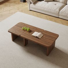 a wooden table sitting on top of a white carpeted floor next to a couch