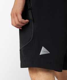 These technical shorts by and wander are made of water-repellent, robust and stretch nylon fabric, and come equipped with functional elements such as multiple pockets and a waistband with an integrated belt. This garment is a must-have for your next hikes, thanks to the reflective stitching that makes you visible in poor visibility conditions. Nylon Techwear Shorts For Outdoor, Outdoor Nylon Techwear Shorts, Outdoor Techwear Nylon Shorts, Techwear Nylon Shorts With Functional Pockets, Black Nylon Utility Shorts, Black Nylon Hiking Shorts, Functional Nylon Shorts For Outdoor Activities, Outdoor Work Shorts With Functional Pockets, Nylon Shorts With Functional Pockets For Outdoor