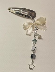 a pair of scissors with charms attached to them