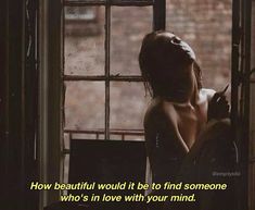 a woman sitting in front of a window with her back turned to the camera and texting how beautiful would it be to find someone who's in love with your mind