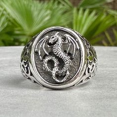 Handcrafted Solid Sterling Silver .925/ Amphiptere Ring 100% hand-polished solid sterling silver Approximate weight 9.7 grams Splendid Dragon ring with its feet holding on to a pentagram properly crafted in solid 925 sterling silver. Dragons is a well-known mythical creature from many ages and cultures. Dragon can symbolize supernatural power, wisdom, strength, and hidden knowledge. This unique dragon design is inspired by Celtics pattern. This magnificent piece will be a very good addition to y Adjustable Sterling Silver Dragon Jewelry, Adjustable Sterling Silver Jewelry With Dragon Design, Dragon Design Ring Jewelry Gift, Dragon Design Ring Jewelry For Gift, Sterling Silver Dragon Design Ring, White Gold Polished Skull Ring Gift, White Gold Skull Ring With Polished Finish, White Gold Skull Ring With Polished Finish Gift, Adjustable Dragon Design Ring