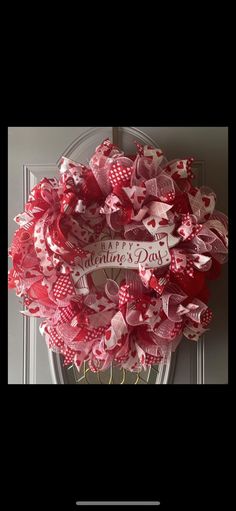 a red and white wreath with hearts on the front door for valentine's day