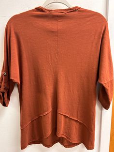 This season, look top-notch in the Midwest Top! Featuring a burnt orange hue, you'll be sure to stand out from the crowd. And with a v neck, quarter length sleeves, and a relaxed fit, you'll enjoy maximum comfort with maximum style. Get ready to look (and feel!) amazing! This top is available in X-Small, Small and Medium! Curated from cotton, modal, and spandex. To care for this top machine wash in cold water with like colors and tumble dry on low heat. This top is a fun twist on a basic tee mak Black Maxi Skirt, Boutique Homes, Black Maxi, Flat Color, Basic Tee, White Sneakers, Burnt Orange, Cold Water, Maxi Skirt