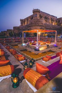 an instagram photo of the inside of a wedding venue with orange and purple couches