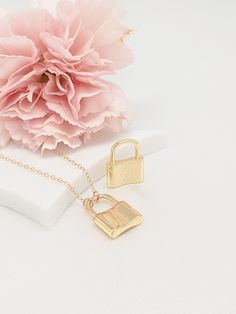 "All items ordered 5/14/21 - 5/30/21 will be shipped out on 5/31/21 Our gift to you 10% off your first purchase. Details here - http:/eepurl.com/dpVPBz Our love lock necklaces are perfect stand alone or layering pieces. Locks are suspended on our signature gold fill chain. Lots of love and symbolism in these pieces. They make thoughtful gifts or that something special for yourself! DETAILS 14 k fill chain and components Charm high shine finish gold plate This listing is for one tiny lock necklac Everyday Locket Pendant Charm Necklace, Minimalist Everyday Jewelry With Lock Detail, Everyday Initial Pendant Locket Charm Necklace, Best Friend Gift Pendant Charm Necklace With Adjustable Chain, Small Everyday Necklace With Charms, Small Charm Necklace With Lobster Clasp For Gift, Silver Lock Necklace Gift, Silver Necklace With Lock Gift, Silver Necklace With Lock As Gift