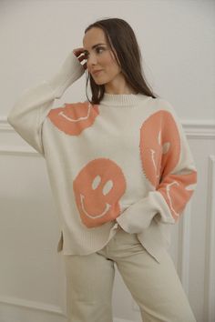 happy face sweatshirt with an oversized fit, long sleeves and side slits Trendy Oversized Soft Knit Sweatshirt, Trendy Crew Neck Sweater, Cute Oversized Sweater For Spring, Playful Soft Knit Sweater For Fall, Trendy Relaxed Fit Sweater, Oversized Cotton Trendy Sweater, Trendy Oversized Cotton Sweater, Casual Spring Sweatshirt With Soft Knit, Casual Spring Soft Knit Sweatshirt