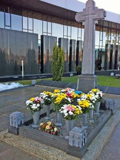 a cross with flowers in front of it