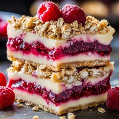 raspberry cheesecake bars stacked on top of each other