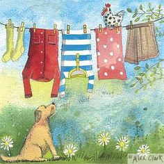 a dog sitting in the grass looking at clothes hanging from a line on a clothesline