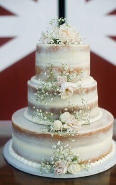 a three tiered cake with flowers on top